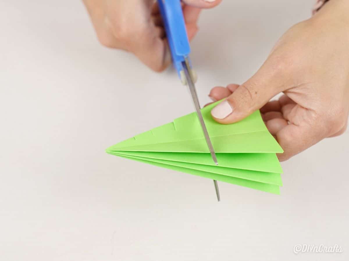 ножницы режут бумагу зеленого дерева